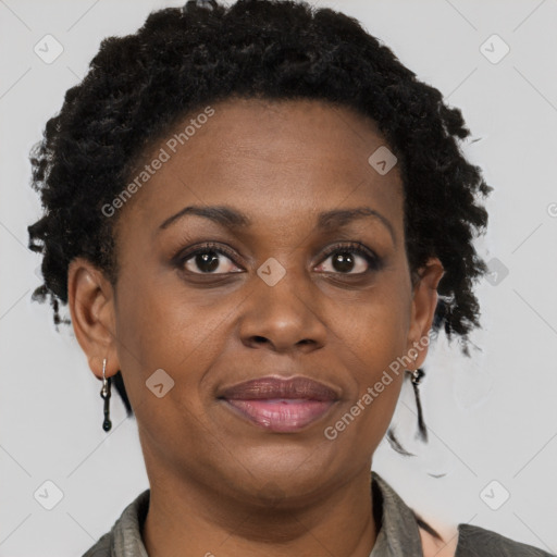 Joyful black adult female with short  brown hair and brown eyes