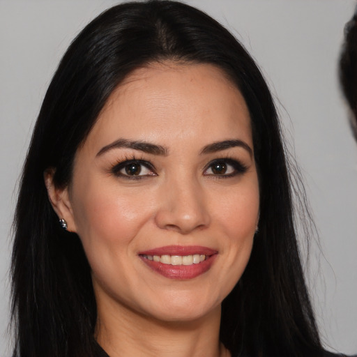Joyful white young-adult female with long  black hair and brown eyes