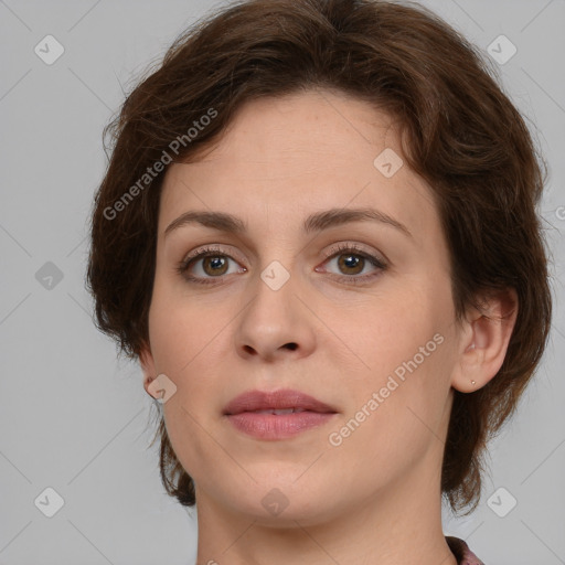 Joyful white young-adult female with medium  brown hair and green eyes