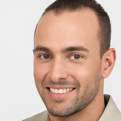 Joyful white young-adult male with short  brown hair and brown eyes