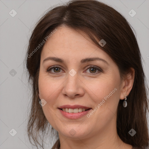 Joyful white adult female with medium  brown hair and brown eyes