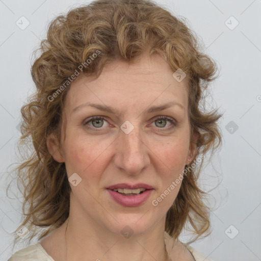 Joyful white adult female with medium  brown hair and blue eyes