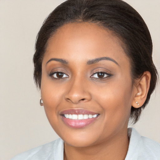 Joyful black young-adult female with medium  brown hair and brown eyes