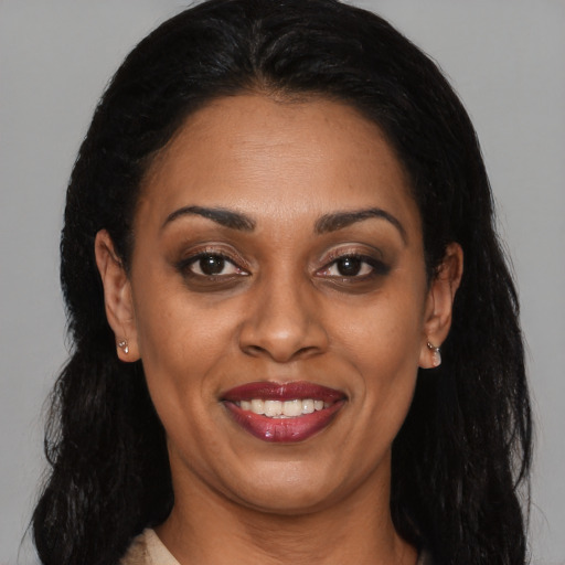 Joyful latino adult female with long  brown hair and brown eyes