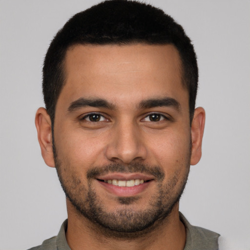 Joyful white young-adult male with short  black hair and brown eyes