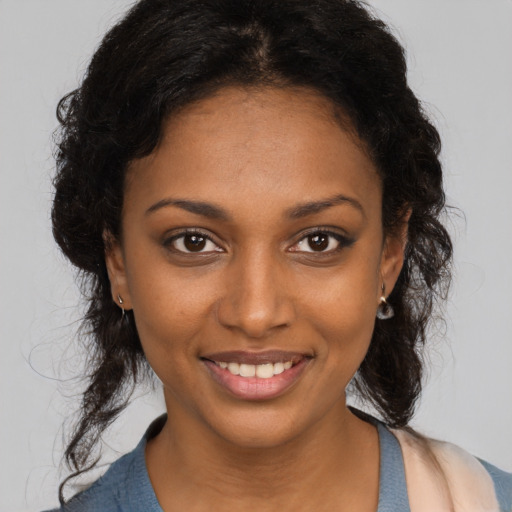 Joyful black young-adult female with medium  brown hair and brown eyes