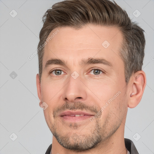 Joyful white adult male with short  brown hair and brown eyes