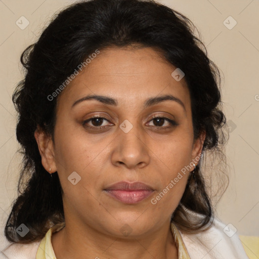 Joyful latino adult female with medium  brown hair and brown eyes