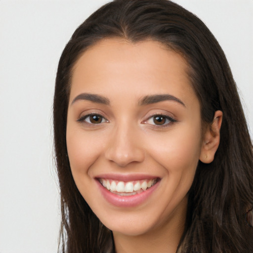 Joyful white young-adult female with long  brown hair and brown eyes