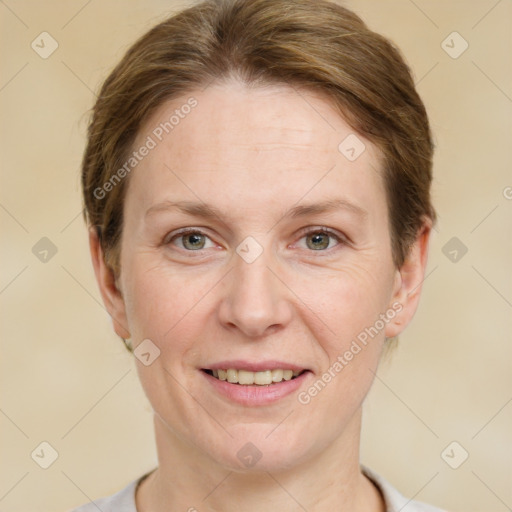 Joyful white adult female with short  brown hair and grey eyes