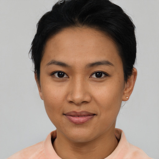 Joyful asian young-adult female with short  black hair and brown eyes
