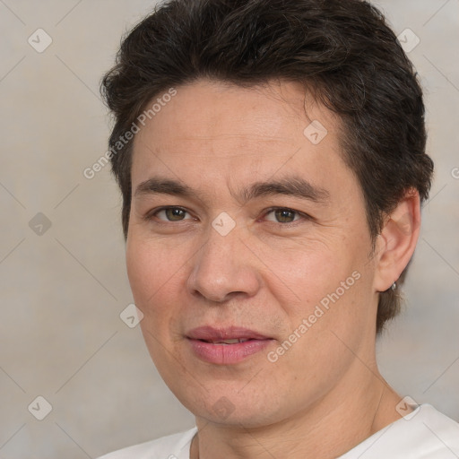 Joyful white adult male with short  brown hair and brown eyes