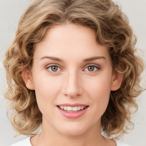 Joyful white young-adult female with medium  brown hair and green eyes