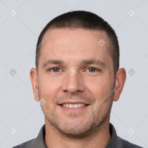 Joyful white adult male with short  brown hair and brown eyes