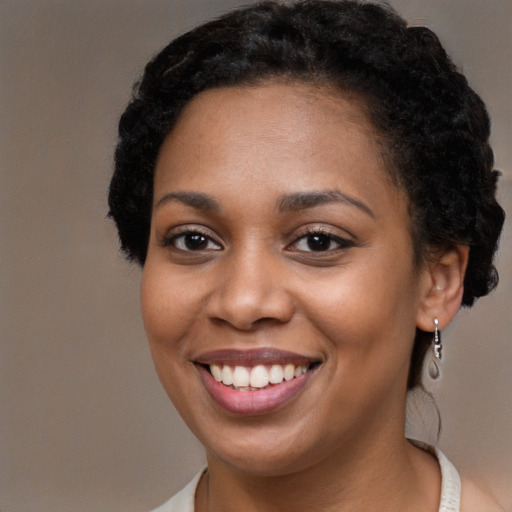 Joyful black young-adult female with short  brown hair and brown eyes