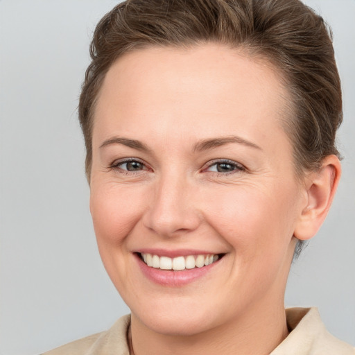 Joyful white young-adult female with medium  brown hair and brown eyes