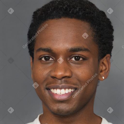 Joyful black young-adult male with short  brown hair and brown eyes