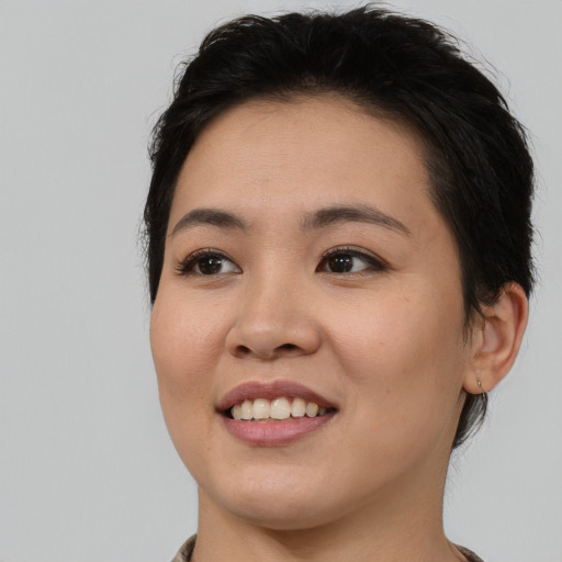 Joyful asian young-adult female with medium  black hair and brown eyes