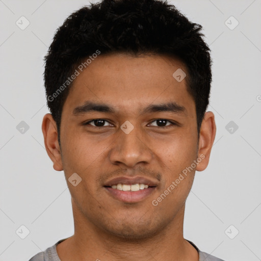 Joyful latino young-adult male with short  black hair and brown eyes