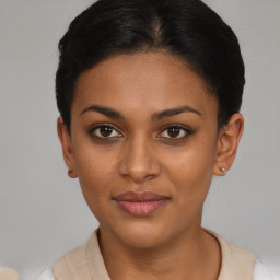 Joyful latino young-adult female with short  brown hair and brown eyes