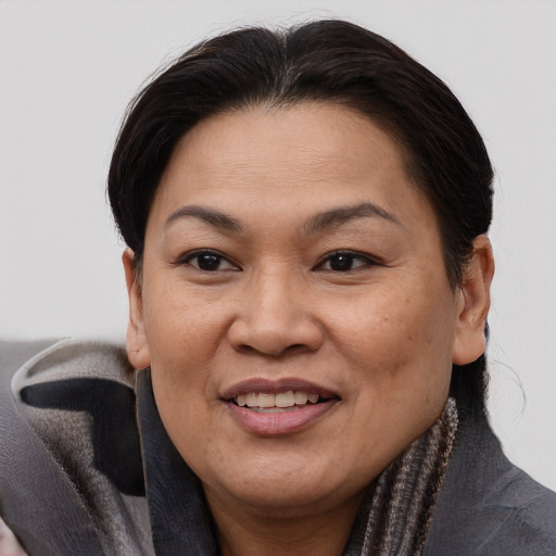 Joyful asian adult female with short  brown hair and brown eyes