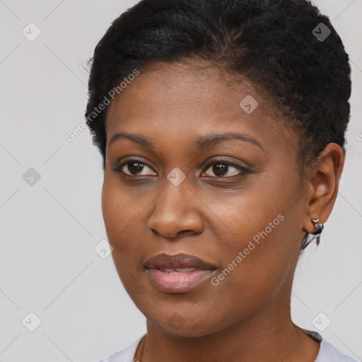 Joyful black young-adult female with short  brown hair and brown eyes