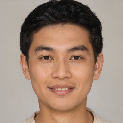 Joyful asian young-adult male with short  black hair and brown eyes