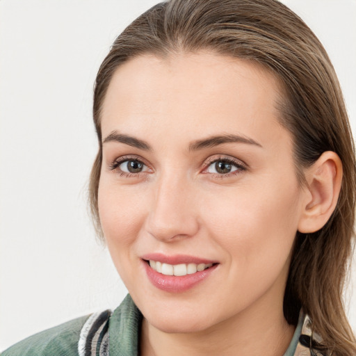 Joyful white young-adult female with medium  brown hair and grey eyes