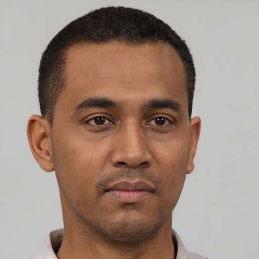 Neutral latino young-adult male with short  black hair and brown eyes