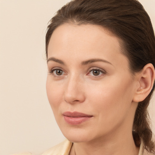 Joyful white young-adult female with medium  brown hair and brown eyes