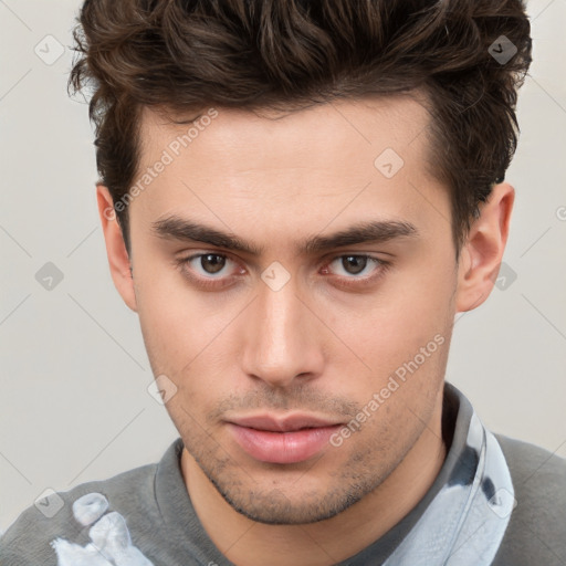 Neutral white young-adult male with short  brown hair and brown eyes