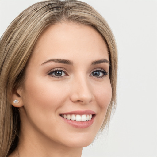 Joyful white young-adult female with long  brown hair and green eyes