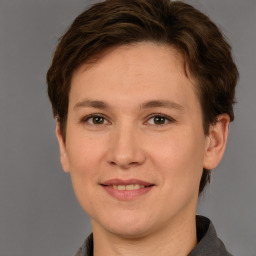 Joyful white young-adult female with short  brown hair and grey eyes