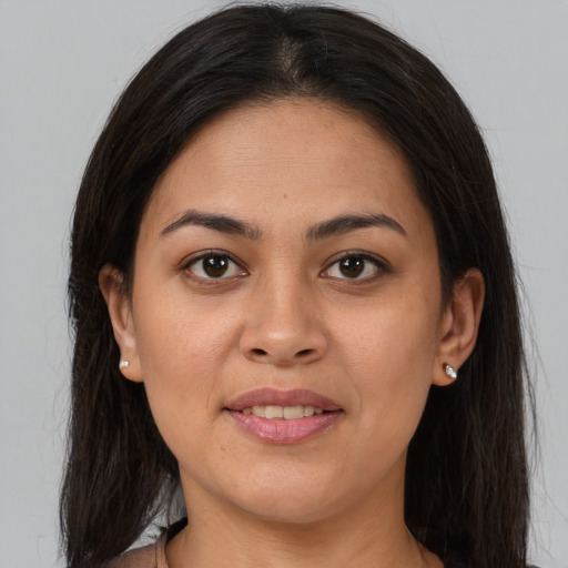 Joyful latino young-adult female with medium  brown hair and brown eyes