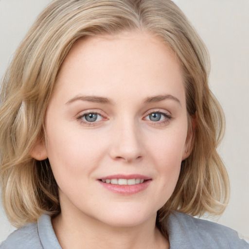 Joyful white young-adult female with medium  brown hair and blue eyes