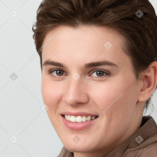 Joyful white young-adult female with short  brown hair and grey eyes