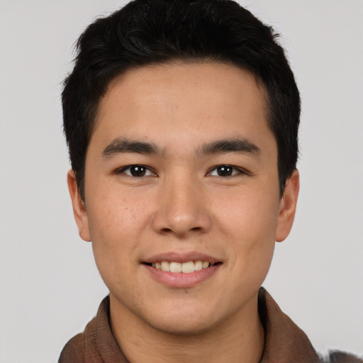 Joyful asian young-adult male with short  brown hair and brown eyes