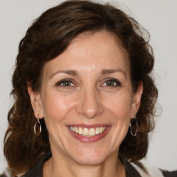 Joyful white adult female with medium  brown hair and grey eyes