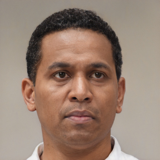 Neutral latino adult male with short  brown hair and brown eyes