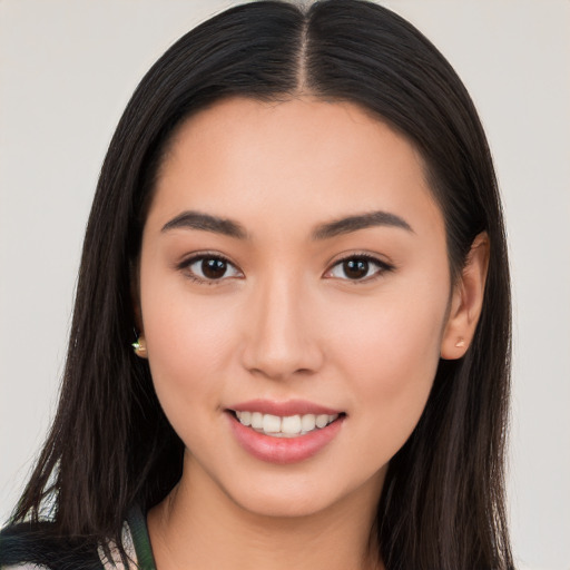 Joyful white young-adult female with long  black hair and brown eyes