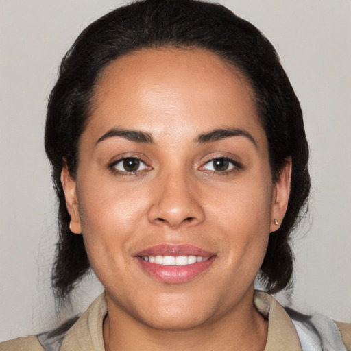 Joyful latino young-adult female with medium  brown hair and brown eyes