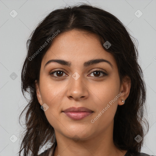 Joyful latino young-adult female with long  brown hair and brown eyes