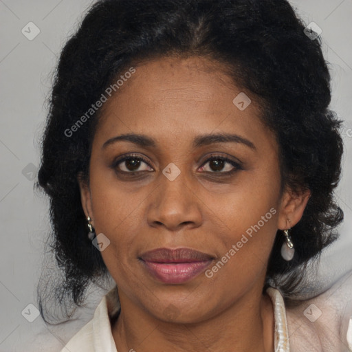 Joyful black adult female with medium  brown hair and brown eyes