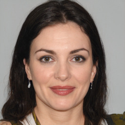 Joyful white adult female with medium  brown hair and brown eyes