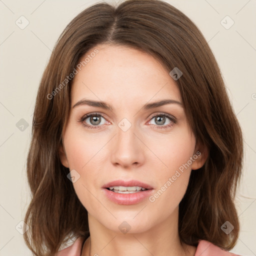 Joyful white young-adult female with medium  brown hair and green eyes