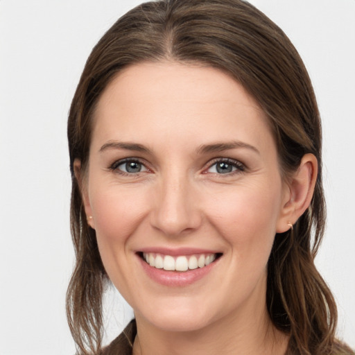 Joyful white young-adult female with medium  brown hair and grey eyes