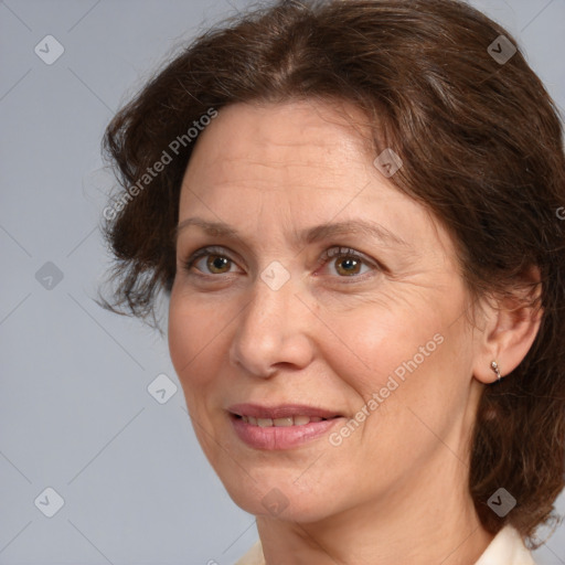 Joyful white adult female with medium  brown hair and brown eyes