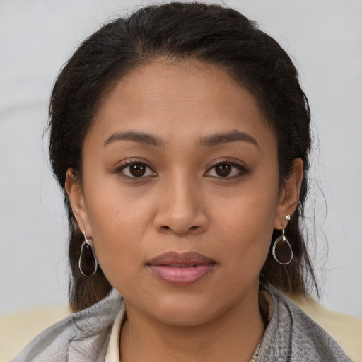 Joyful latino young-adult female with short  brown hair and brown eyes