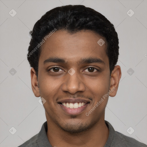 Joyful black young-adult male with short  black hair and brown eyes