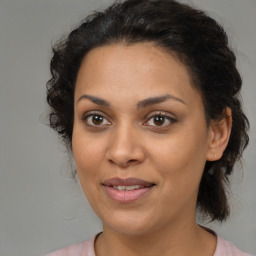 Joyful latino young-adult female with medium  brown hair and brown eyes